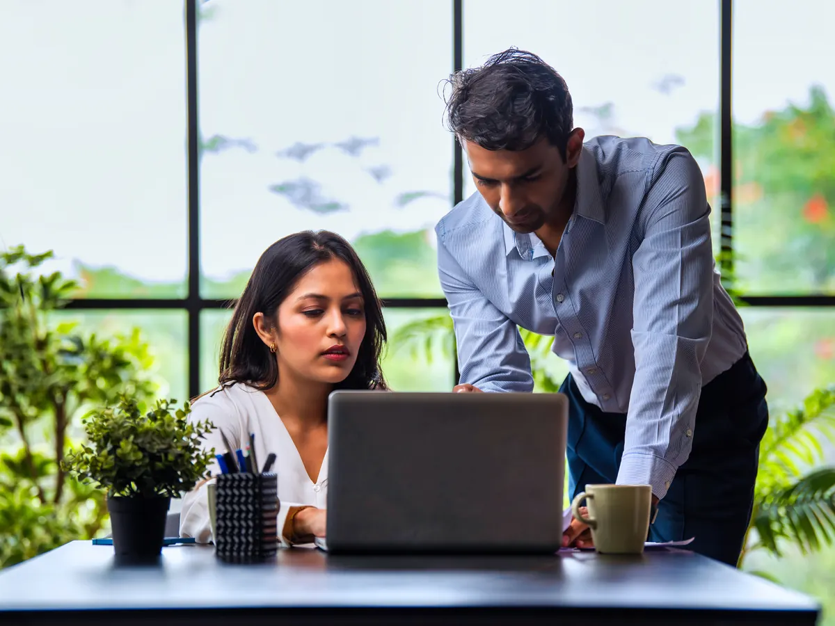 Two colleagues working together at a laptop